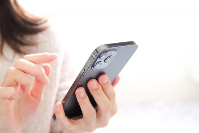 操作智慧型手機的女人的手